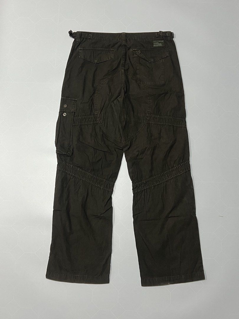 90’s Stussy Authentic Gear Cargo Pants Brown (Category: Jeans) located in Caloocan City. Submitted by lostarchive_55 (Listing ID 1465917630, Image 2). Description: - Brand: Stussy Authentic Gear - Style: Cargo pants with relaxed fit through the leg - Color: Dark brown wash - Size: 32 (adjustable waist tabs on both sides for a custom fit) - Pockets: Utility thigh pockets with button closures, extra right-leg zip pocket, and rear flap pockets - Det