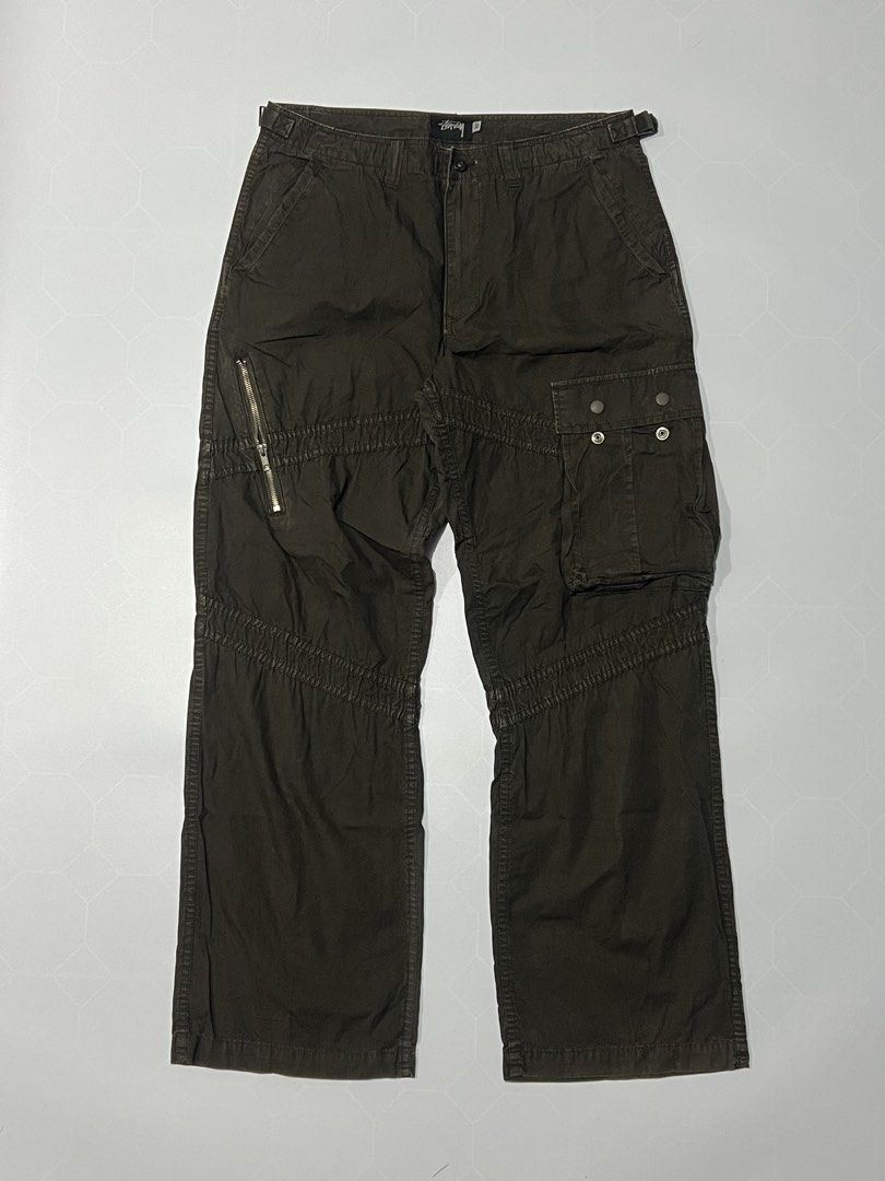 90’s Stussy Authentic Gear Cargo Pants Brown (Category: Jeans) located in Caloocan City. Submitted by lostarchive_55 (Listing ID 1465917630, Image 1). Description: - Brand: Stussy Authentic Gear - Style: Cargo pants with relaxed fit through the leg - Color: Dark brown wash - Size: 32 (adjustable waist tabs on both sides for a custom fit) - Pockets: Utility thigh pockets with button closures, extra right-leg zip pocket, and rear flap pockets - Det