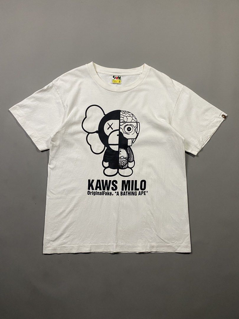 A Bathing Ape APE x KAWS Milo Tee (Category: Tshirts & Polo Shirts ) located in Santa Barbara. Submitted by thrifthub24 (Listing ID 1465771419, Image 1). Description: - Item: KAWS Milo White T-Shirt - Brand: A Bathing Ape (BAPE) - Size: XL - Material: 100% Cotton - Origin: Made in Japan - Condition: Excellent, graphic has no cracking - Details: Features iconic KAWS Milo graphic, classic neck tag, and sleeve tab branding.