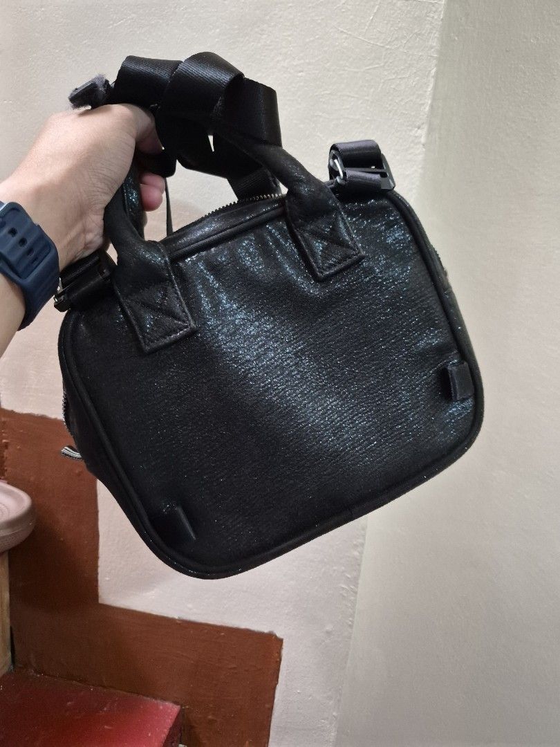 Adidas Black Glitter Mini Handbag (Category: Luxury Bags & Wallets) located in Antipolo. Submitted by prinsesa_dianne (Listing ID 1465940362, Image 3). Description: - Brand: Adidas - Style: Mini handbag / everyday casual bag - Color/Design: Black glitter with silver three stripes on the front - Closure & Handles: Secure zipper closure with dual carry handles - Interior: Clean fabric lining featuring the classic Adidas brand logo label patch - Con