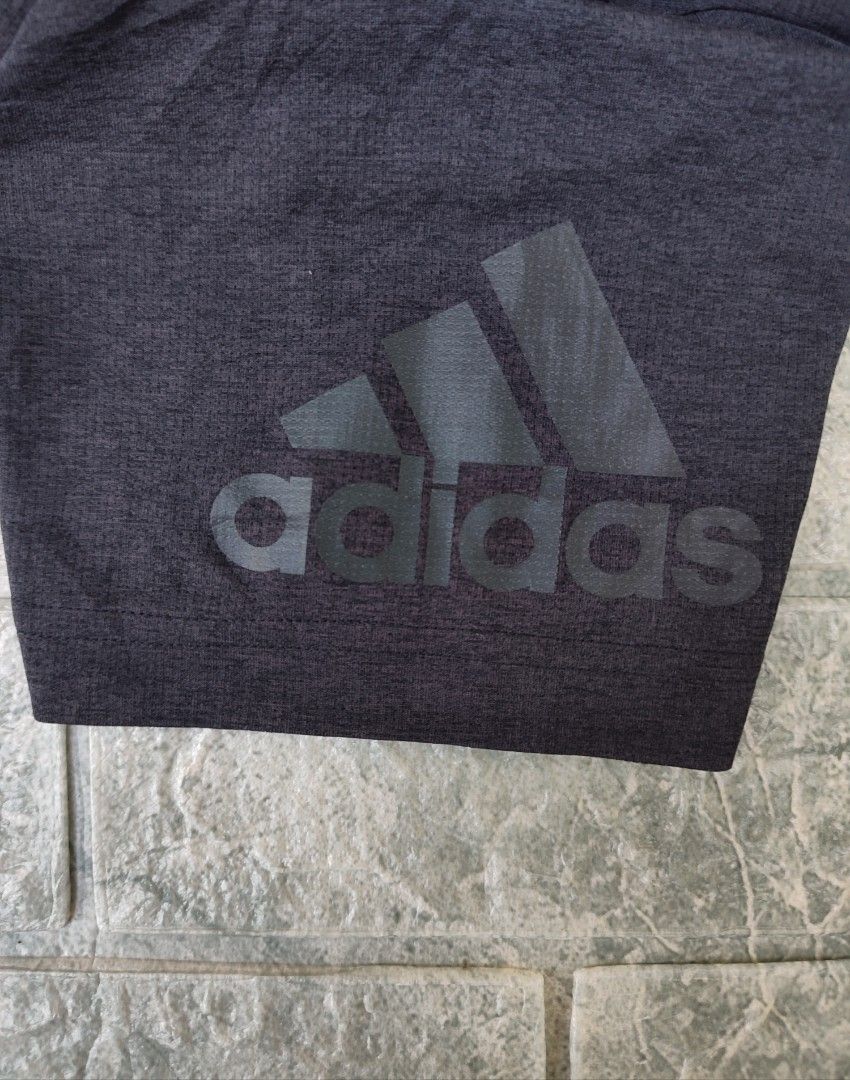 Adidas Climachill Athletic T-Shirt (Category: Activewear) located in Bayambang. Submitted by mon10192816 (Listing ID 1465878880, Image 2). Description: - Width 18¾ - Length 26 - Brand: Adidas Climachill - Color: Dark grey with blue trim - Size: Medium (M) - Material: Lightweight & breathable fabric - Features: Aluminum cooling spheres on inner neckline for temperature control, crew neck, short sleeves, and tonal Adidas logo on the left sleeve - O