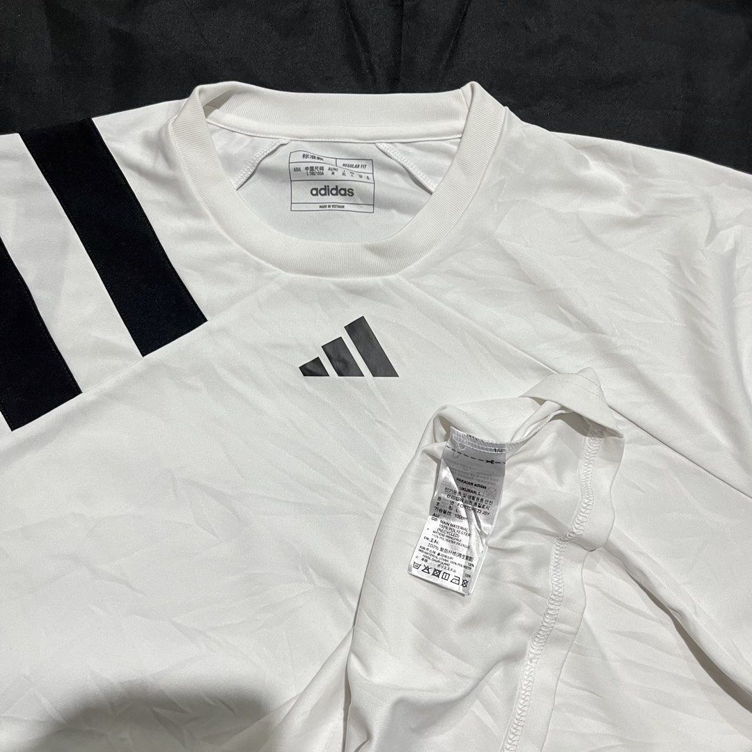 Adidas Fortore 23 Jersey White Black (Category: Activewear) located in Manila. Submitted by giormagne (Listing ID 1465876203, Image 3). Description: - Brand: Adidas - Model: Fortore 23 Jersey - Color: White with black stripes on the right shoulder - Size: L (Regular Fit) - Material: Lightweight polyester with Aeroready technology - Condition: Good, with a small faint stain near the bottom left front; clean collar and back - Best for: Training, gy