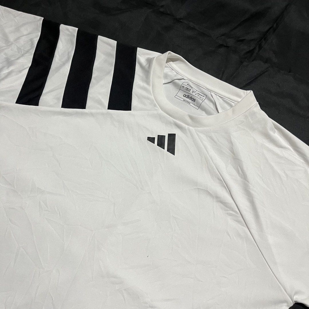 Adidas Fortore 23 Jersey White Black (Category: Activewear) located in Manila. Submitted by giormagne (Listing ID 1465876203, Image 2). Description: - Brand: Adidas - Model: Fortore 23 Jersey - Color: White with black stripes on the right shoulder - Size: L (Regular Fit) - Material: Lightweight polyester with Aeroready technology - Condition: Good, with a small faint stain near the bottom left front; clean collar and back - Best for: Training, gy