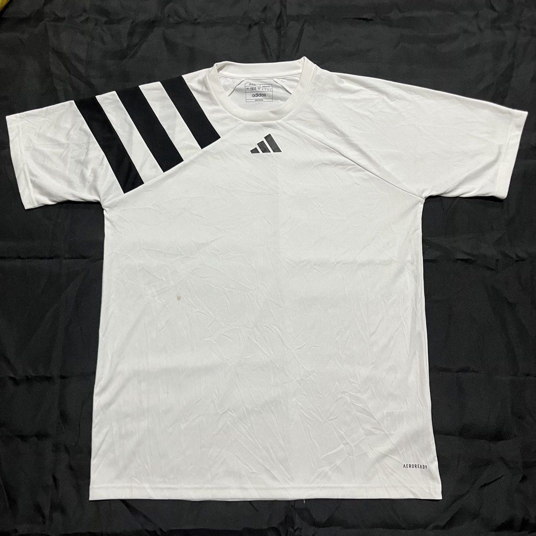 Adidas Fortore 23 Jersey White Black (Category: Activewear) located in Manila. Submitted by giormagne (Listing ID 1465876203, Image 1). Description: - Brand: Adidas - Model: Fortore 23 Jersey - Color: White with black stripes on the right shoulder - Size: L (Regular Fit) - Material: Lightweight polyester with Aeroready technology - Condition: Good, with a small faint stain near the bottom left front; clean collar and back - Best for: Training, gy