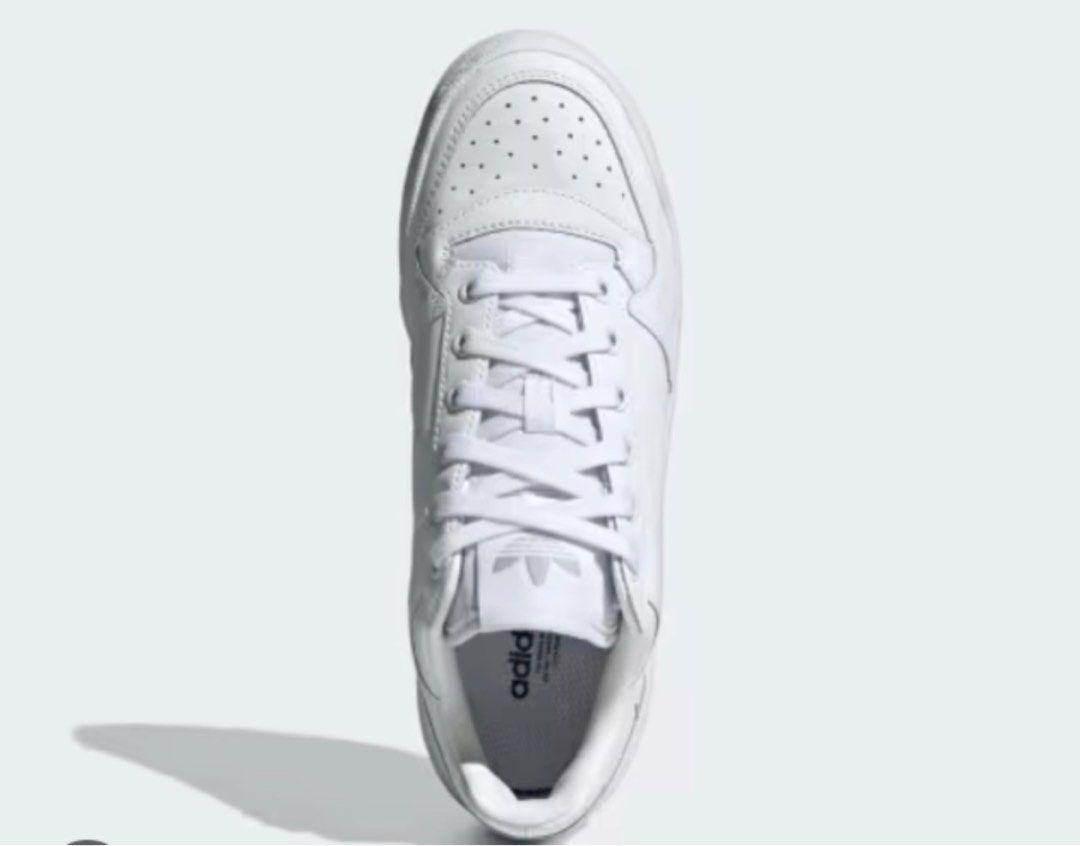 Adidas Forum Low Shoes White Silver (Category: Sneakers) located in Manila. Submitted by oddpenguin_cc96b9 (Listing ID 1465899895, Image 2). Description: - Color: White leather with silver three stripes - Fit: Regular fit with a padded collar for comfort - Features: Perforated toe box for breathability and cushioned midsole for all-day wear - Design: Classic basketball silhouette with a traditional lace-up front and branded tongue label - Conditi