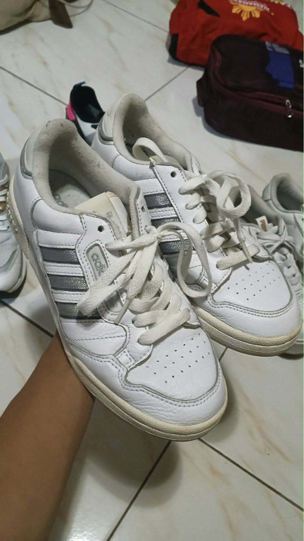 Adidas Forum Low Shoes White Silver (Category: Sneakers) located in Manila. Submitted by oddpenguin_cc96b9 (Listing ID 1465899895, Image 3). Description: - Color: White leather with silver three stripes - Fit: Regular fit with a padded collar for comfort - Features: Perforated toe box for breathability and cushioned midsole for all-day wear - Design: Classic basketball silhouette with a traditional lace-up front and branded tongue label - Conditi