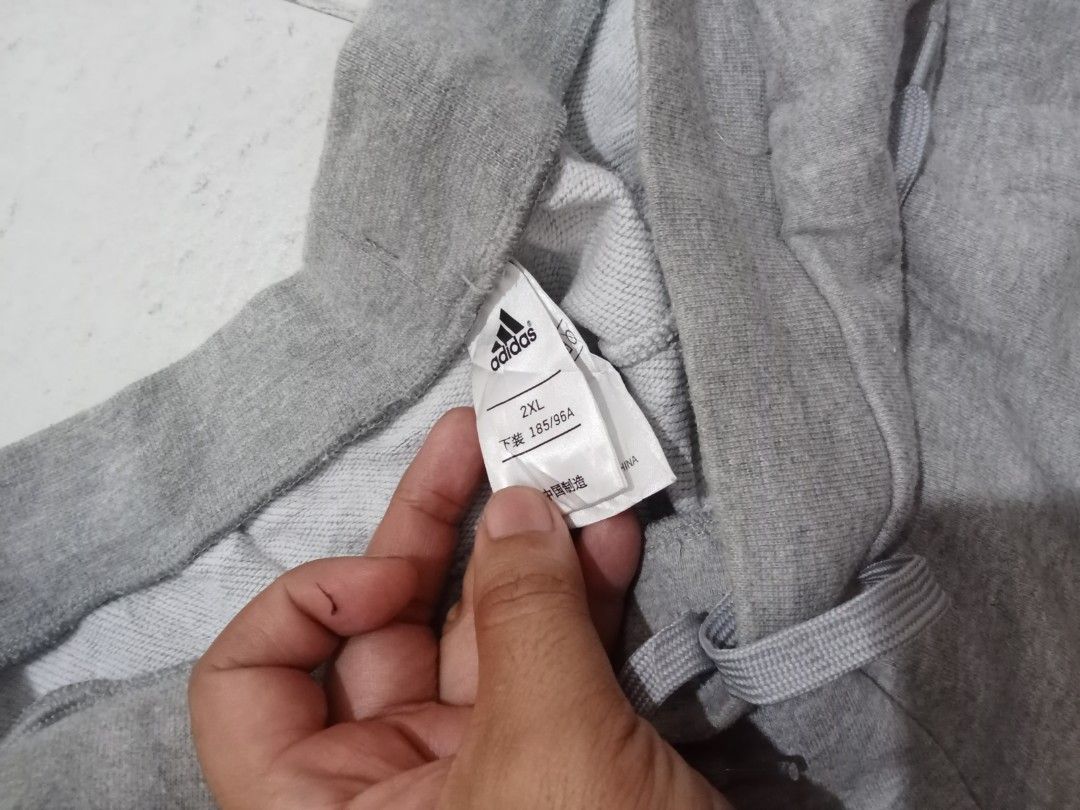 Adidas Grey Jogger Pants 2XL (Category: Joggers) located in Manila. Submitted by kitkathrift (Listing ID 1465867378, Image 2). Description: - Brand: Adidas - Color: Grey - Size: 2XL - Drawstring waist for an adjustable fit - Ribbed cuffs at the bottom hems - Small embroidered Adidas logo on the front hip - Soft cotton blend interior - Ideal for casual everyday wear and lounging -need wash.