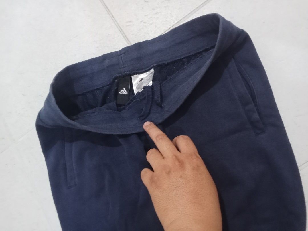 Adidas Navy Blue Joggers Sweatpants (Category: Joggers) located in Manila. Submitted by kitkathrift (Listing ID 1465867656, Image 2). Description: - Authentic navy blue Adidas sweatpants - Bold white lettering down the left leg - Adjustable elastic drawstring waistband for a custom fit - Convenient side slip pockets - Snug ribbed ankle cuffs - Perfect for workouts, gym sessions, or casual lounging.