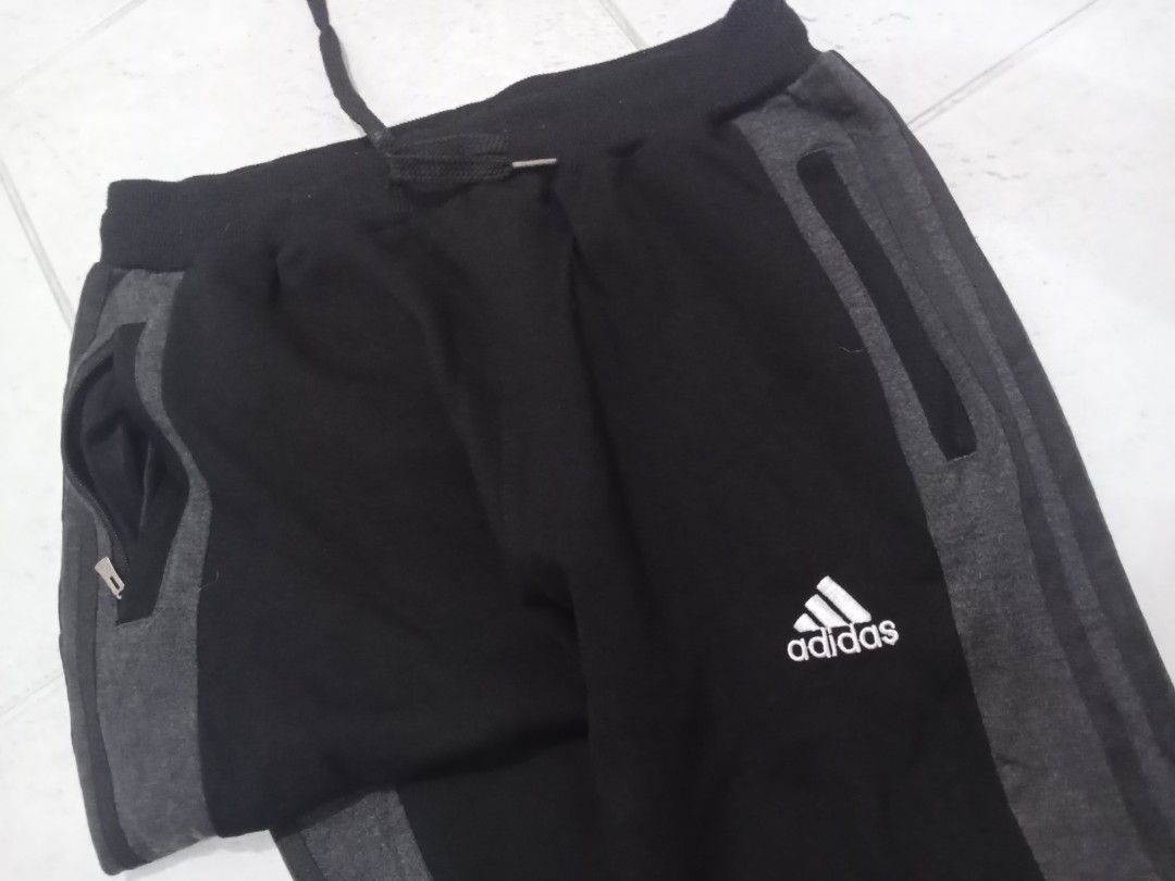 Adidas Performance Track Pants 2XL Black (Category: Joggers) located in Manila. Submitted by kitkathrift (Listing ID 1465867539, Image 2). Description: - Brand: Adidas Performance - Size: 2XL (Standard relaxed athletic fit) - Color: Black with grey side panels - Features: Zippered side pockets, adjustable drawstring waist, ribbed ankle cuffs - Origin: Made in China (PT Nike Indonesia manufacturer tag) - Mode of Payment & Shipping: MOP via GCash/B