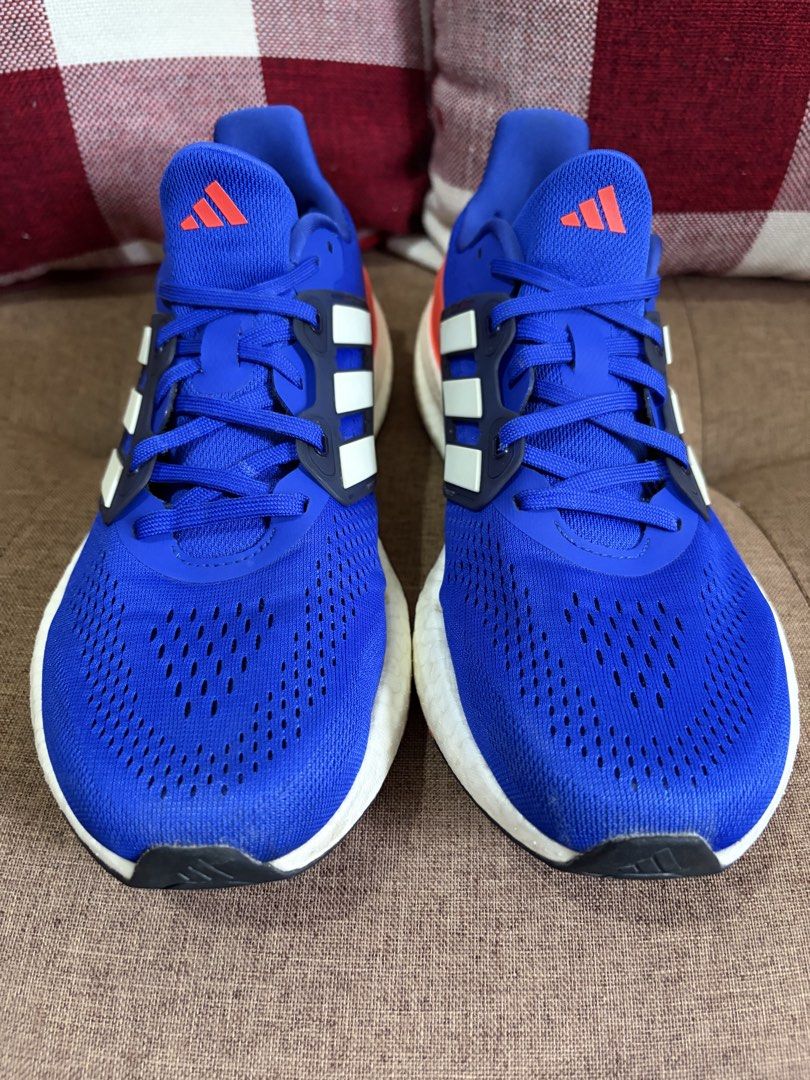 [Used] Adidas Pureboost 23 (US10/UK9.5/28cm) (Category: Sneakers) located in Quezon City. Submitted by smosh_67 (Listing ID 1465801112, Image 1). Description: - Brand: Adidas - Color: Bright blue with red-orange heel counters and white stripes - Sole: White Boost midsole with durable rubber outsole - Upper: Lightweight mesh with toe box ventilation - Closure: Regular lace-up - Condition: Clean overall with minor wear on the soles (8.5/10) -Box: N