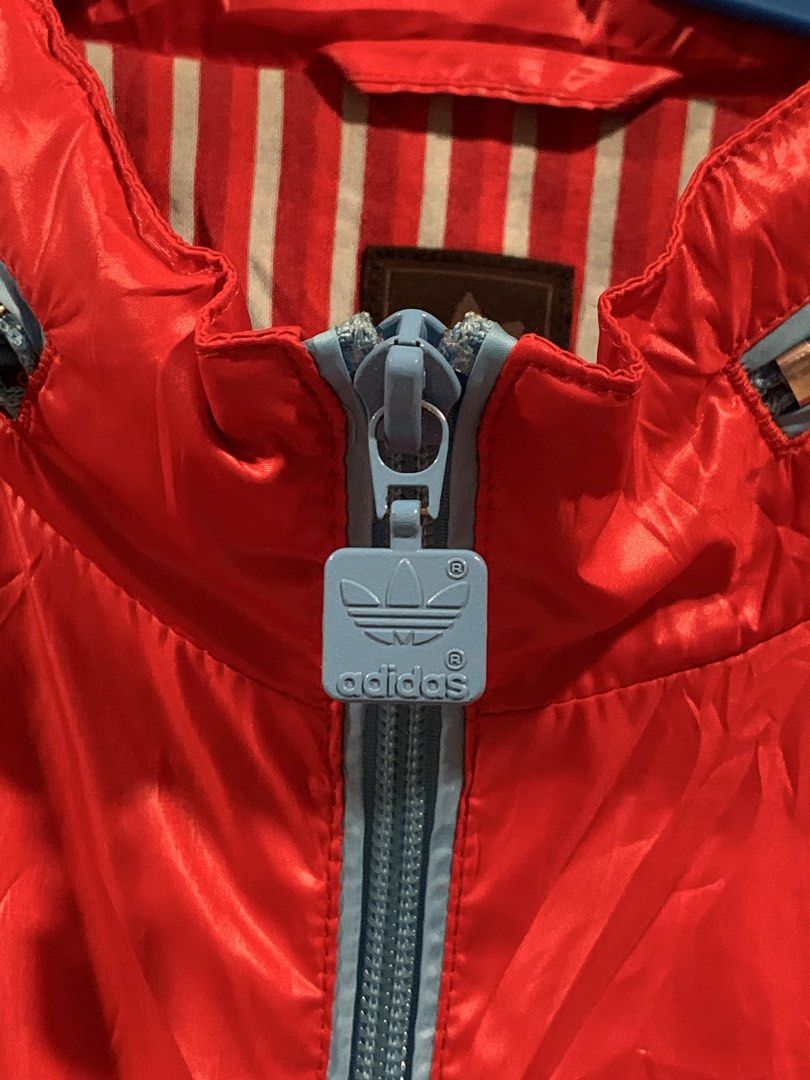 Adidas Red Blue Track Jacket Windbreaker Size M (Category: Coats, Jackets and Outerwear) located in Don Carlos. Submitted by buddysemaj (Listing ID 1465922168, Image 2). Description: - Brand: Adidas - Color: Red with light blue stripes and zipper pull - Inner Lining: Striped (red and light blue) - Size: Medium - Origin: Made in China - Style: Zip-up front with high collar - Condition: Excellent, pre-loved - Mode of Payment: GCash or Bank Transfer