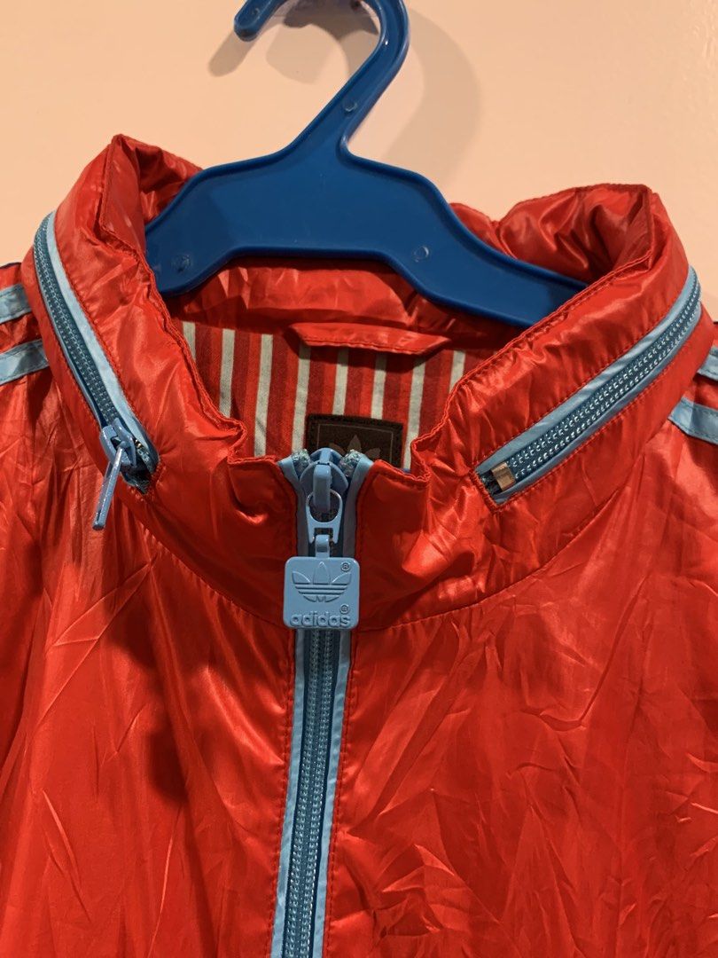 Adidas Red Blue Track Jacket Windbreaker Size M (Category: Coats, Jackets and Outerwear) located in Don Carlos. Submitted by buddysemaj (Listing ID 1465922168, Image 3). Description: - Brand: Adidas - Color: Red with light blue stripes and zipper pull - Inner Lining: Striped (red and light blue) - Size: Medium - Origin: Made in China - Style: Zip-up front with high collar - Condition: Excellent, pre-loved - Mode of Payment: GCash or Bank Transfer