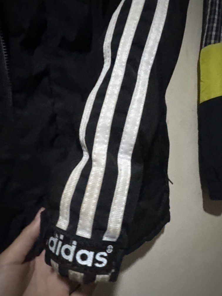 Adidas Reversible Puffer Jacket (Category: Coats, Jackets and Outerwear) located in Danao, Cebu. Submitted by welvirinec29053 (Listing ID 1465786214, Image 2). Description: The item shown is a vintage/Y2K-era Adidas hooded puffer windbreaker jacket featuring the iconic three-stripes down the sleeves and a reversible design (often flipping between a nylon shell and puffer). with detachable hoodie dimes 23x29 color rate 10/10.