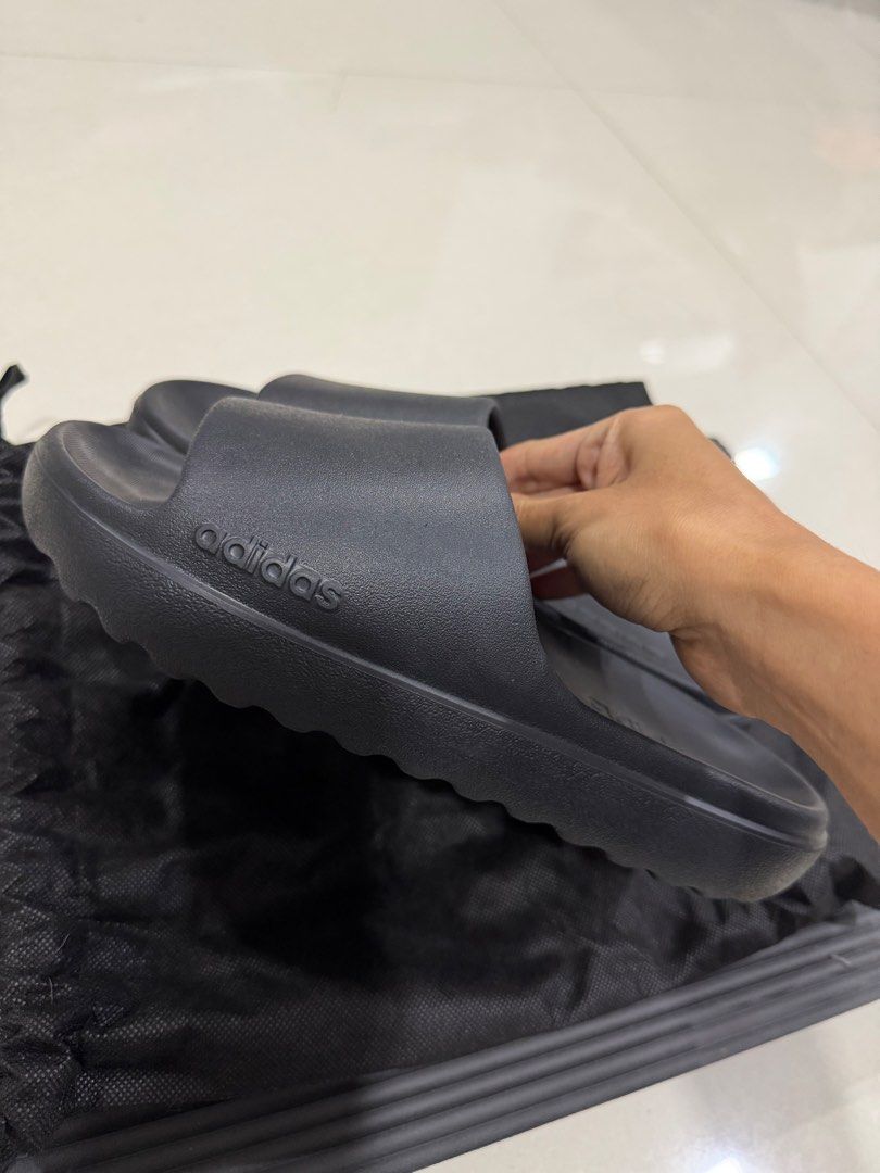 Adidas Slides Black Sandals (Category: Slippers & Slides) located in Manila. Submitted by imprincessg888 (Listing ID 1465863151, Image 2). Description: - Brand: Adidas - Color: All Black - Condition: Great, with very minimal wear on the soles - Design: Clean slip-on style with textured footbed and side branding - Inclusions: Comes with a black dust bag - Ideal for: Everyday casual use, running errands, or lounging at home.