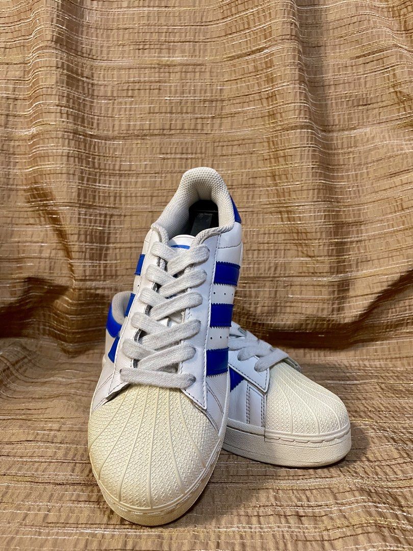 Adidas Superstar Blue XLG (Category: Sneakers) located in Manila. Submitted by phil.fabulous (Listing ID 1465848458, Image 2). Description: - Brand: Adidas Superstar - Colorway: White leather with bold royal blue stripes and heel tab - Features: Classic shell-toe, slightly chunky platform sole, and iconic gold foil branding - Condition: Clean upper with minimal creasing; soles show light wear - Inclusions: Original white laces included - Ideal fo