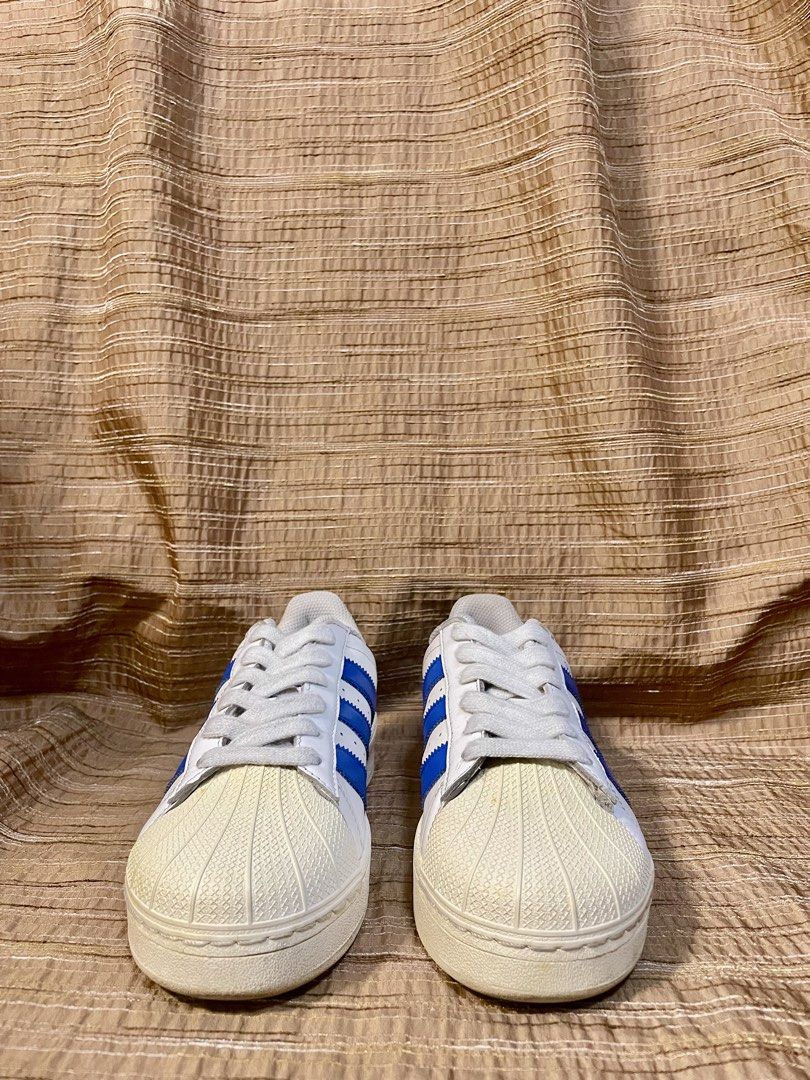 Adidas Superstar Blue XLG (Category: Sneakers) located in Manila. Submitted by phil.fabulous (Listing ID 1465848458, Image 3). Description: - Brand: Adidas Superstar - Colorway: White leather with bold royal blue stripes and heel tab - Features: Classic shell-toe, slightly chunky platform sole, and iconic gold foil branding - Condition: Clean upper with minimal creasing; soles show light wear - Inclusions: Original white laces included - Ideal fo