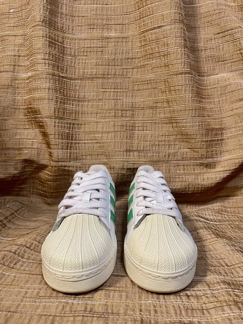 Adidas Superstar Green XLG (Category: Sneakers) located in Manila. Submitted by phil.fabulous (Listing ID 1465847939, Image 3). Description: - Brand/Model: Adidas Superstar Platform - Colorway: White with Green stripes and heel tab - Design: Classic shell toe, thick platform sole, and iconic gold 'SUPERSTAR' lettering - Condition: Clean overall, with minimal signs of wear on uppers and soles - Inclusions: Comes with original white laces - Style: 