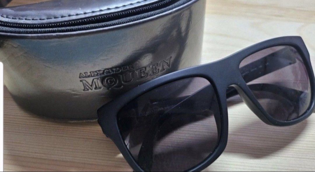 Alexander McQueen MCQ 0023/S Sunglasses with Case (Category: Sunglasses & Eyewear) located in Quezon City. Submitted by kcobs (Listing ID 1465840784, Image 1). Description: - Brand: Alexander McQueen - Model: MCQ 0023/S QHCY1 - Frame: Matte black, bold square silhouette - Size: 55-16-145 - Lenses: Dark tinted - Details: Embossed branding along the arms - Inclusions: Original hard clamshell case with zipper closure and branded cleaning cloth - Con