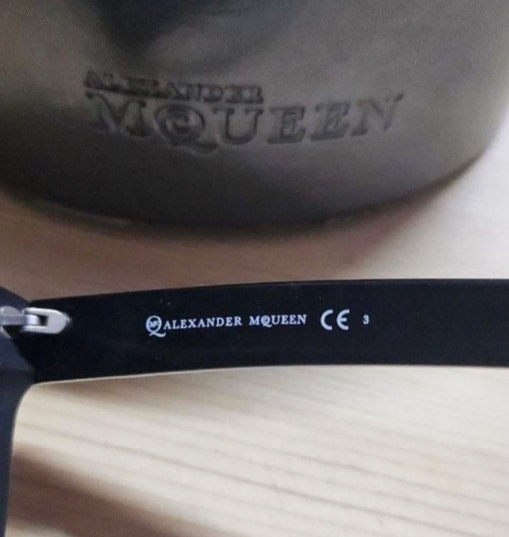 Alexander McQueen MCQ 0023/S Sunglasses with Case (Category: Sunglasses & Eyewear) located in Quezon City. Submitted by kcobs (Listing ID 1465840784, Image 2). Description: - Brand: Alexander McQueen - Model: MCQ 0023/S QHCY1 - Frame: Matte black, bold square silhouette - Size: 55-16-145 - Lenses: Dark tinted - Details: Embossed branding along the arms - Inclusions: Original hard clamshell case with zipper closure and branded cleaning cloth - Con