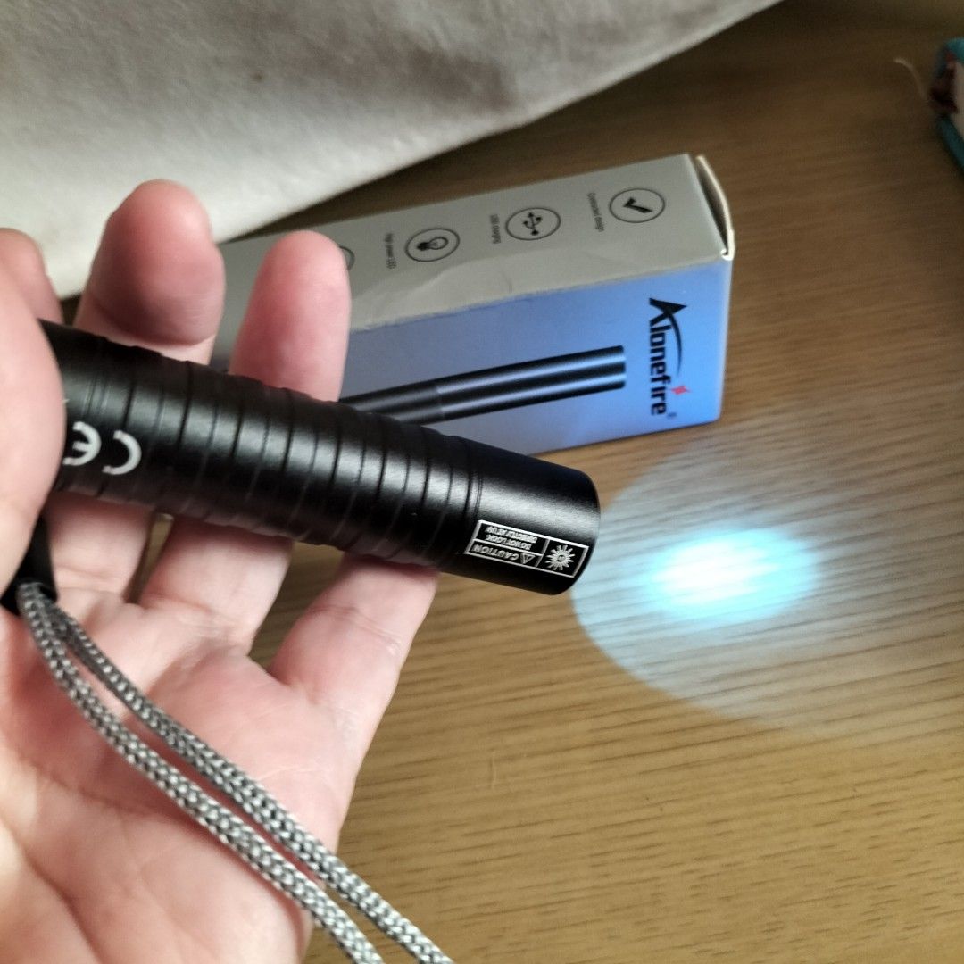 Alonefire SV99 Multifunctional Flashlight USB Charging (Category: Lighting) located in Paranaque City. Submitted by decluttering-all (Listing ID 1465795800, Image 2). Description: - Brand: Alonefire SV99 - Color: Black - Material: Durable aluminum alloy shell - Light Source: High power LED - Power: USB rechargeable with built-in lithium battery - Design: Convenient tail switch - Inclusions: Original box and wrist lanyard included p169 only used o