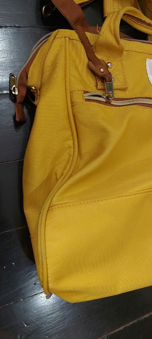 Anello Boston a4 2-way Shoulder Bag Yellow (Category: Shoulder Bags) located in Quezon City. Submitted by lisolette (Listing ID 1465897991, Image 3). Description: - Brand: Anello - Color: Mustard yellow with brown accents - Style: 2-way bag (can be hand-carried or worn as a shoulder/crossbody bag) - Includes: Matching detachable and adjustable strap - Compartments: Main compartment with secure zipper closure and front zip pocket - Material: Durab