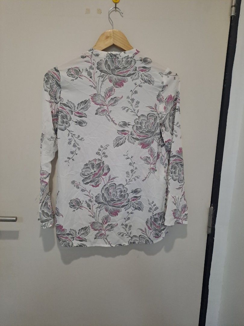 Ann Taylor floral longsleve (Category: Longsleeves) located in Manila. Submitted by joanbalde39643 (Listing ID 1465863191, Image 3). Description: This piece is an Ann Taylor Factory Floral Long-Sleeve Blouse. It features a lightweight, off-white fabrication adorned with a detailed sketch-style grayscale floral pattern highlighted by subtle pink accents.