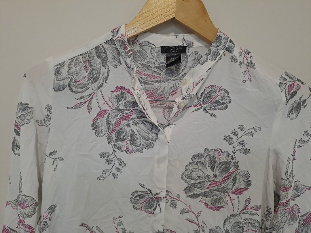 Ann Taylor floral longsleve (Category: Longsleeves) located in Manila. Submitted by joanbalde39643 (Listing ID 1465863191, Image 2). Description: This piece is an Ann Taylor Factory Floral Long-Sleeve Blouse. It features a lightweight, off-white fabrication adorned with a detailed sketch-style grayscale floral pattern highlighted by subtle pink accents.