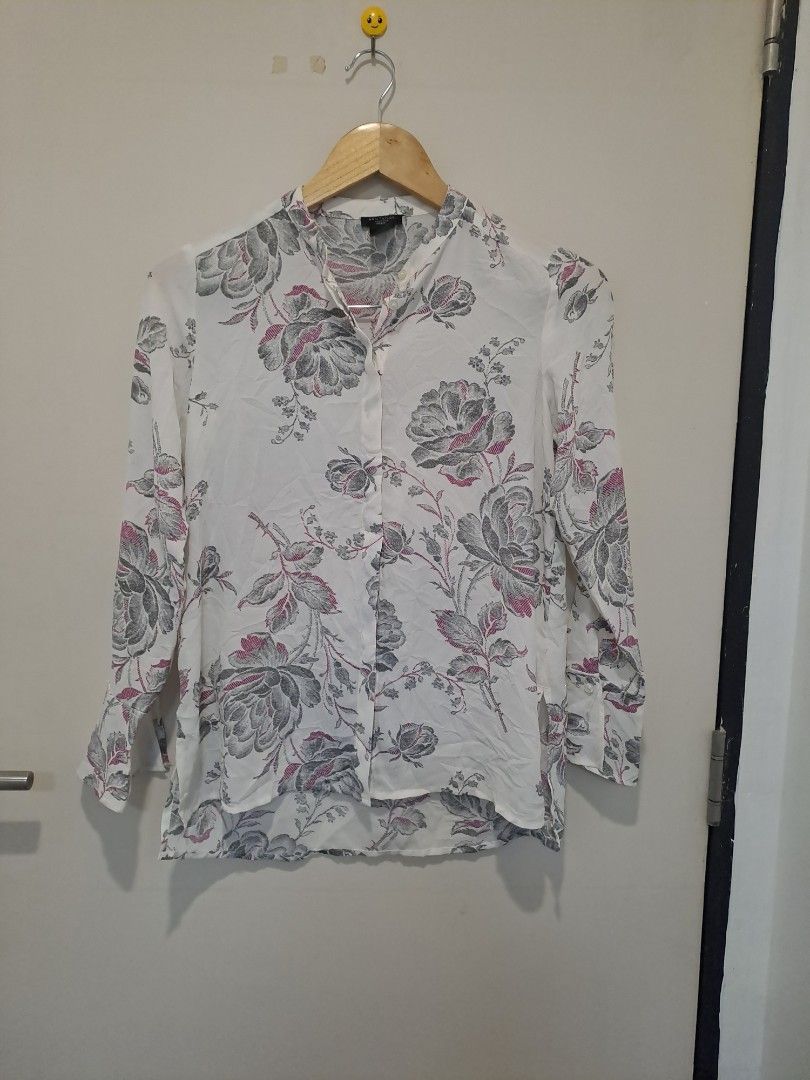 Ann Taylor floral longsleve (Category: Longsleeves) located in Manila. Submitted by joanbalde39643 (Listing ID 1465863191, Image 1). Description: This piece is an Ann Taylor Factory Floral Long-Sleeve Blouse. It features a lightweight, off-white fabrication adorned with a detailed sketch-style grayscale floral pattern highlighted by subtle pink accents.