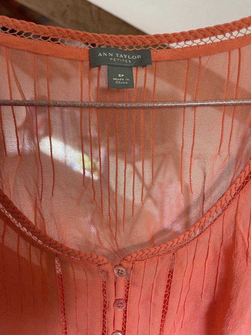 Ann Taylor Petites Coral Blouse (Category: Blouses) located in Baybay. Submitted by shikita27906 (Listing ID 1465850820, Image 2). Description: - Brand: Ann Taylor Petites - Size: SP (Petite Small) - Color: Coral - Material: Lightweight, breathable fabric - Details: Button-down front (7 white buttons), round neck with braided trim, sheer yoke panel, vertical pleated pin tucks.