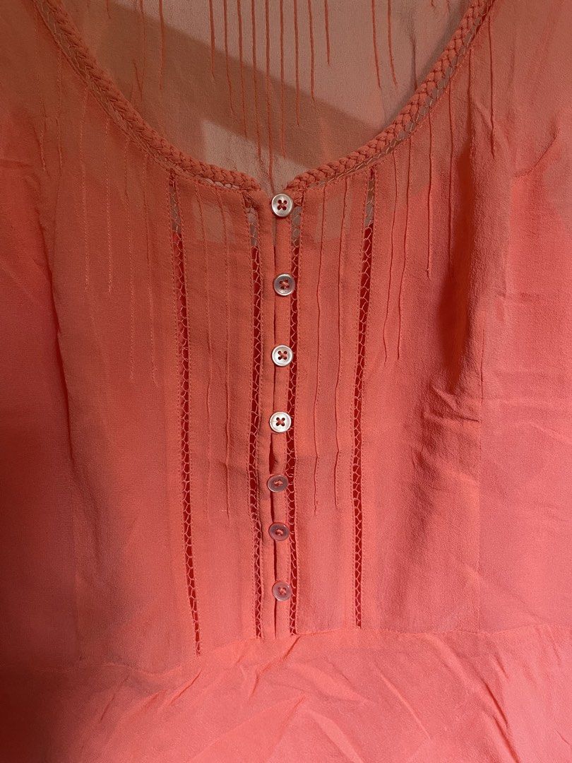 Ann Taylor Petites Coral Blouse (Category: Blouses) located in Baybay. Submitted by shikita27906 (Listing ID 1465850820, Image 3). Description: - Brand: Ann Taylor Petites - Size: SP (Petite Small) - Color: Coral - Material: Lightweight, breathable fabric - Details: Button-down front (7 white buttons), round neck with braided trim, sheer yoke panel, vertical pleated pin tucks.