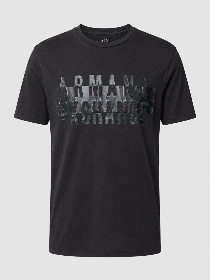 Armani Exchange Black Graphic T-Shirt (Category: Tshirts & Polo Shirts ) located in Manila. Submitted by sheilam.autumnstreet (Listing ID 1465901701, Image 1). Description: - Brand: Armani Exchange - Color: Black - Design: Bold textured logo print across the chest - Fit: Classic crew neck with short sleeves - Material: Soft and comfortable cotton - Condition: cracked print - Style: Perfect for casual daily wear.