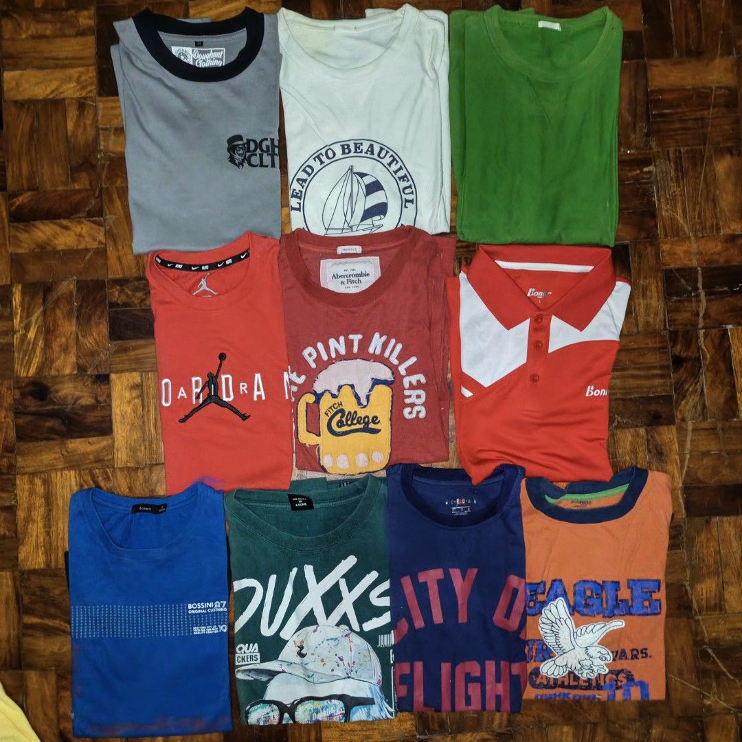 Assorted Graphic Tees and Polo Bundle, Take All For 800 (Category: Tshirts & Polo Shirts ) located in Manila. Submitted by ekko_0xx (Listing ID 1465883899, Image 1). Description: Bundle of 10 assorted tees and one polo shirt. Includes brands like Jordan, Abercrombie & Fitch, and Bossini. Various graphic prints ranging from beer mugs to sailboats and text designs. Different colors like red, blue, green, and orange. Mix of sizes. Great for casual e