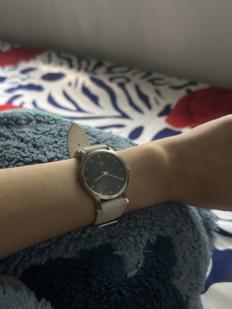 Authentic Calvin Klein K26221 * Swiss Made Watch (Category: Women's Watches) located in Bacoor. Submitted by fiercepenguin_c471dd (Listing ID 1465811628, Image 2). Description: - Brand: Calvin Klein (Model: K26221) - Movement: Swiss-made quartz - Display: Black face with clear 1-12 numbers, silver-tone stainless steel case - Strap: White genuine leather, comfortable fit - Water Resistance: Up to 30m (100 feet) - Style: Clean, minimalist look perf