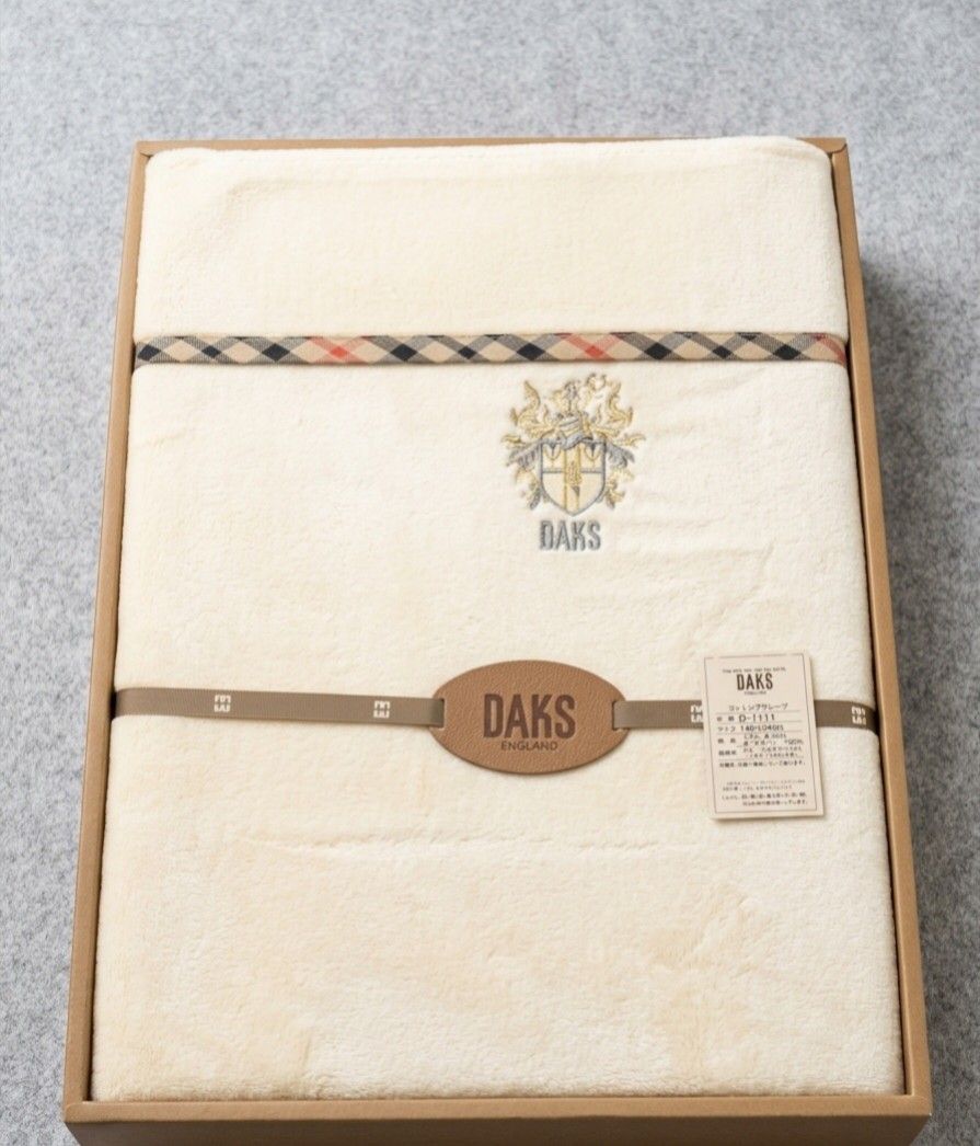 AUTHENTIC GAURANTEE 💯 DAKS LONDON BLANKET (Category: Bedding & Towels) located in Las Pinas. Submitted by outerwearsmanila (Listing ID 1465863927, Image 2). Description: A cream-colored DAKS London cotton fleece or pile bed sheet/blanket featuring the brand's signature. 📌WHY DAKS IS SO EXPENSIVE? DAKS London is expensive because it operates as a heritage British luxury fashion house with a reputation built over more than 130 years. 📌Royal Warr