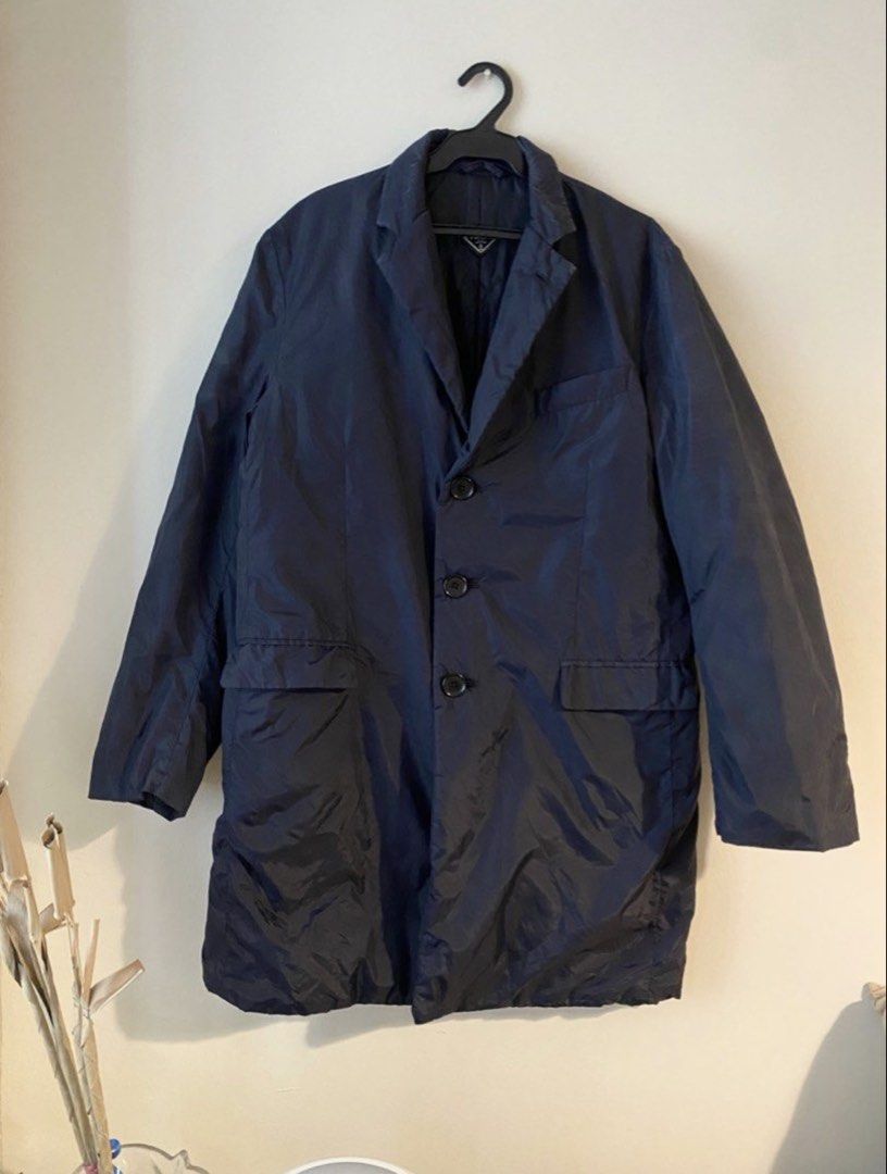 Authentic Prada 90s Buttoned Single-Breasted Nylon Coat (Category: Luxury Apparel) located in Mandaluyong City. Submitted by wear_your_style (Listing ID 1465812911, Image 1). Description: Bought preloved in Japan. Nylon material. Midnight blue but close to black ang color. Para siyang sports jacket na may konting padding. Perfect for Baguio/autumn weather but I used this is a topper during winter. Surprisingly magaan. Maraming pockets: 3 secret p