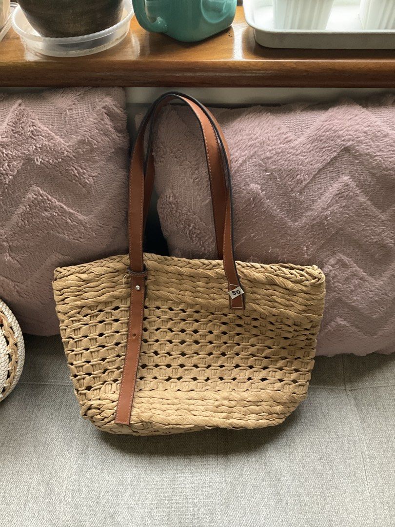 Banig bag (Category: Beach Bags) located in Quezon City. Submitted by freshspaces (Listing ID 1465775694, Image 1). Description: - Woven straw body in neutral beige and tan - Comfortable brown leather-look shoulder straps - Roomy open-top interior for daily essentials - Lightweight and perfect for summer outfits and beach trips.