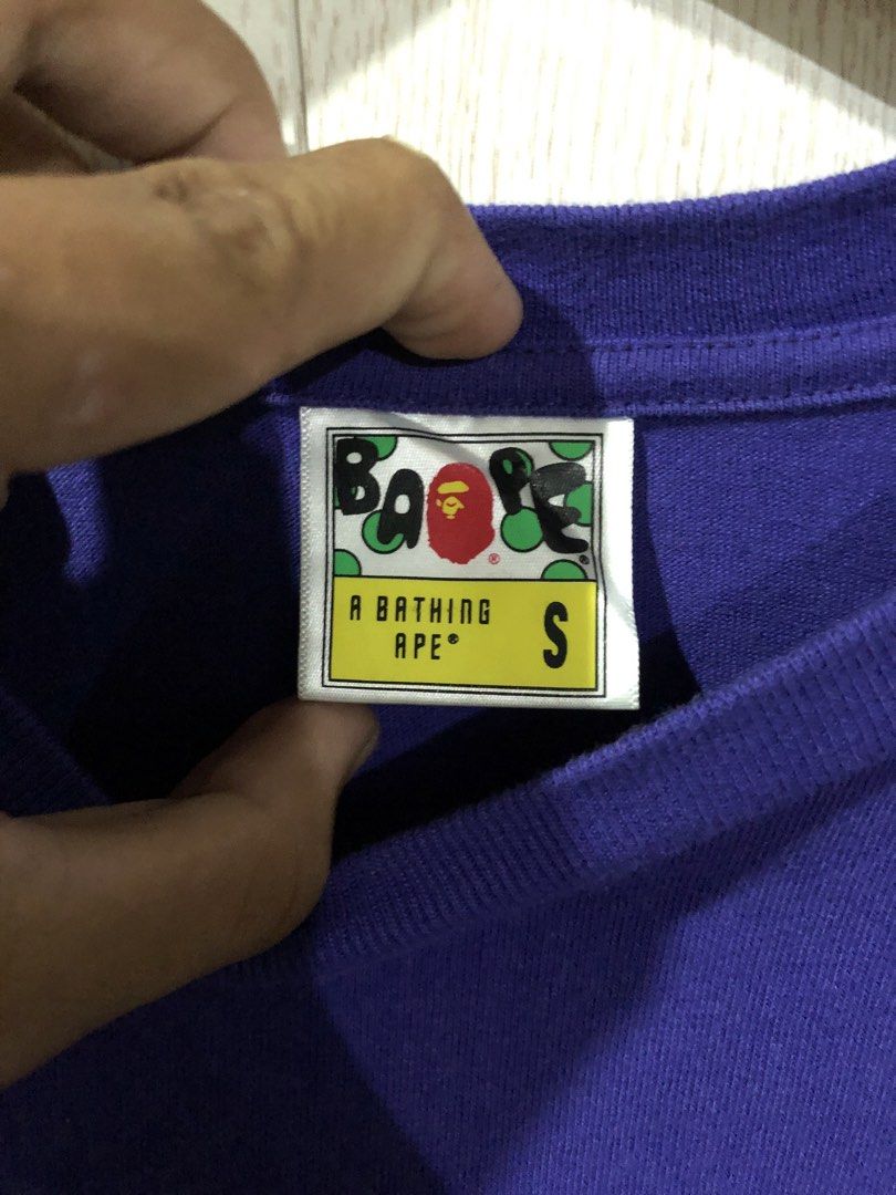 BAPE PONR Purple T-Shirt (Category: Tshirts & Polo Shirts ) located in Magsaysay. Submitted by ryns_thrifting (Listing ID 1465896249, Image 3). Description: - Brand: BAPE (A Bathing Ape) - Color: Purple - Size: S (tag attached inside collar) - Design: Small embroidered chest logo & PONR graphic on upper back - Authenticity: Includes Nowhere Co., Ltd wash tag - Condition: Clean fabric overall, well-maintained.