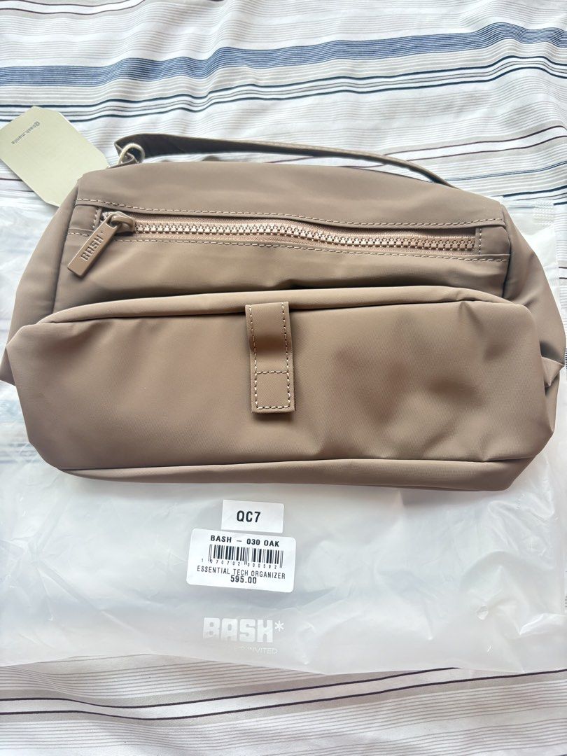 Bash Essential Tech Organizer in Oak (Category: Luxury Bags & Wallets) located in Bacoor. Submitted by rnsphmllr (Listing ID 1465913305, Image 2). Description: - Brand: Bash Essential Tech Organizer - Color: Oak - Condition: Brand new with tags, unused inside original packaging - Material: Durable nylon construction - Features: Multiple zippered compartments and a sturdy carry handle - Perfect for: Keeping chargers, cords, and daily gadgets neatl