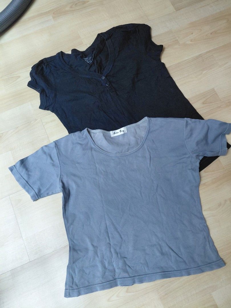 Basic tops (Category: Blouses) located in Kuala Lumpur. Submitted by glittermermaidbarbie (Listing ID 1465859194, Image 1). Description: - Bundle of 2 basic everyday t-shirts for just RM10 - 1x Black PDL Henley Tee: Size M, 100% cotton, 2-button front - 1x Grey Echo Bay Crewneck Tee n material, short sleeves - Pair them with skirts or jeans - Perfect for daily rotation.