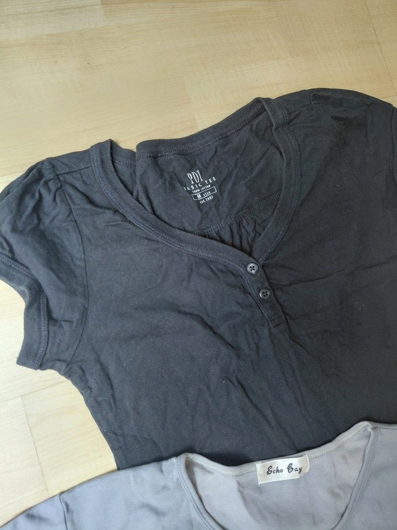 Basic tops (Category: Blouses) located in Kuala Lumpur. Submitted by glittermermaidbarbie (Listing ID 1465859194, Image 2). Description: - Bundle of 2 basic everyday t-shirts for just RM10 - 1x Black PDL Henley Tee: Size M, 100% cotton, 2-button front - 1x Grey Echo Bay Crewneck Tee n material, short sleeves - Pair them with skirts or jeans - Perfect for daily rotation.
