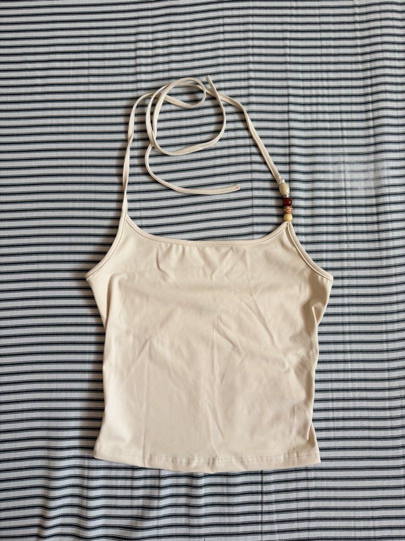 Beaded halter neck cream cami top (Category: Sleeveless) located in Cavite. Submitted by chinitolover (Listing ID 1465769741, Image 1). Description: - NEVER BEEN WORN - Fit: Soft, stretchy fabric that hits around the waist - Condition: Minimal wear, great basic for warm weather.
