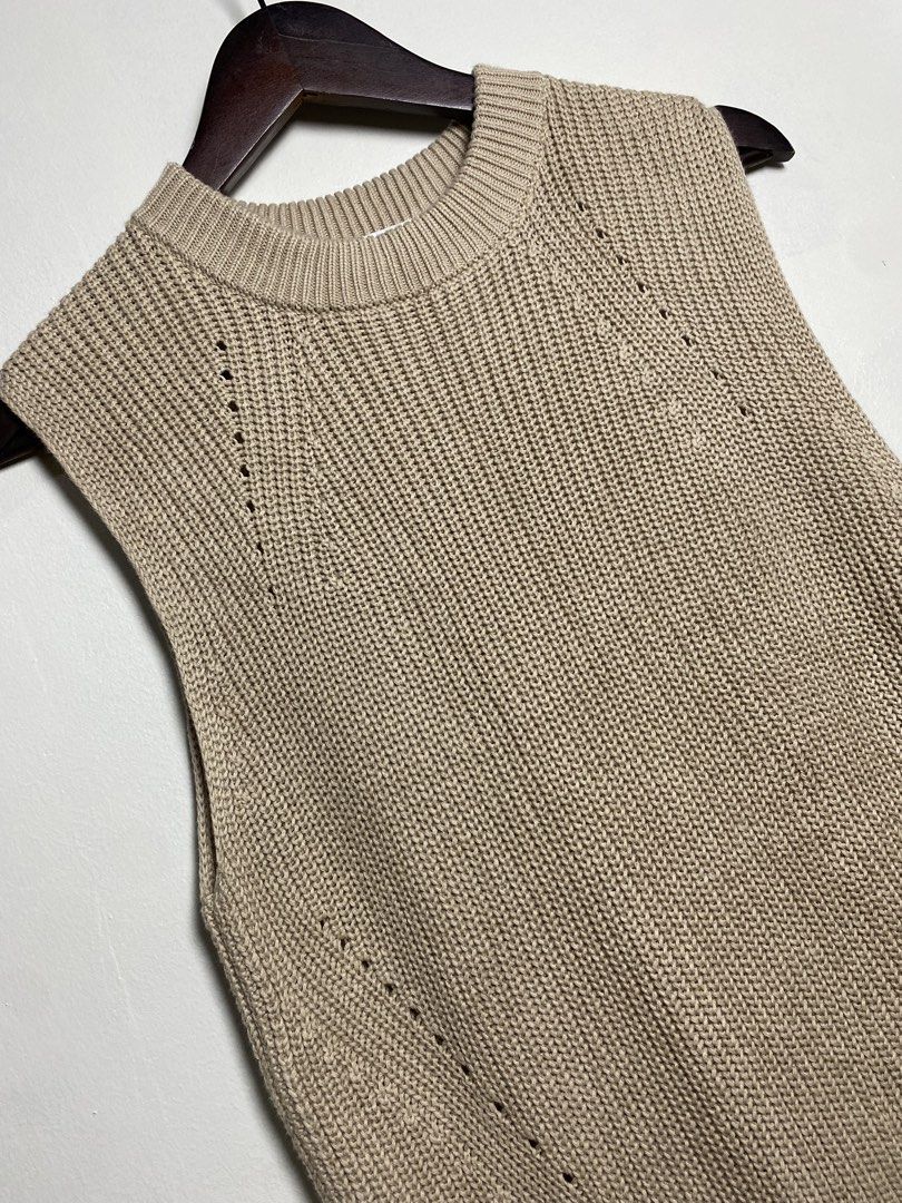 Beige high low knit vest (Category: Others Tops) located in Makati City. Submitted by indaysukaycloset (Listing ID 1465820071, Image 2). Description: BEIGE HIGH-LOW KNIT VEST Brand: UNIQLO Size: M on tag - Fits S-M Color: Beige / Light Taupe Details: - W-16 Front L-24 Back L-28 (laid flat, in inches) - Round neck sleeveless vest - High-low / longer back hem with side slits - Chunky knit with eyelet / perforated line details - Material: 100% Cotto
