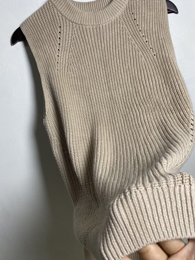 Beige high low knit vest (Category: Others Tops) located in Makati City. Submitted by indaysukaycloset (Listing ID 1465820071, Image 3). Description: BEIGE HIGH-LOW KNIT VEST Brand: UNIQLO Size: M on tag - Fits S-M Color: Beige / Light Taupe Details: - W-16 Front L-24 Back L-28 (laid flat, in inches) - Round neck sleeveless vest - High-low / longer back hem with side slits - Chunky knit with eyelet / perforated line details - Material: 100% Cotto