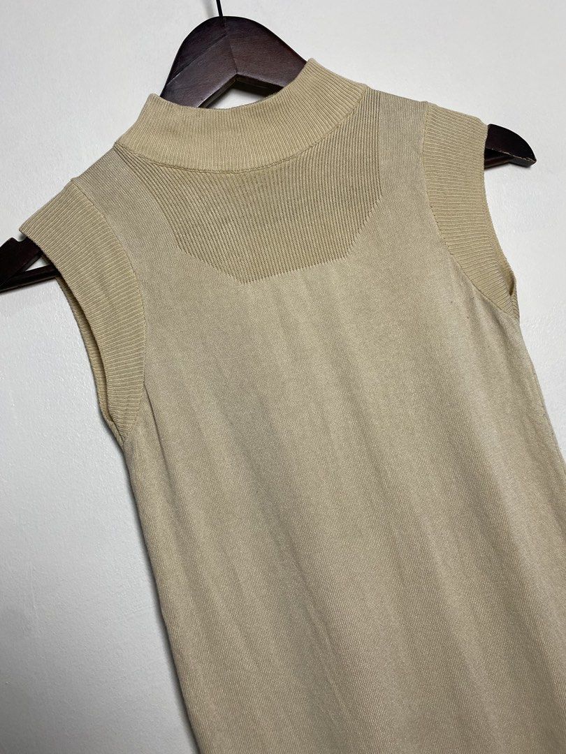 Beige mock neck sleeveless top (Category: Others Tops) located in Makati City. Submitted by indaysukaycloset (Listing ID 1465848477, Image 2). Description: BEIGE MOCK NECK SLEEVELESS TOP Brand: Japan Brand (no tag visible) Size: Fits XS-S up to medium kasi stretchable Color: Beige / Khaki / Nude Details: - W-13.5 L-22.5 (laid flat, in inches) - small sizing, fitted - Mock neck / high neck sleeveless knit - Ribbed neckline, armhole and shoulder de