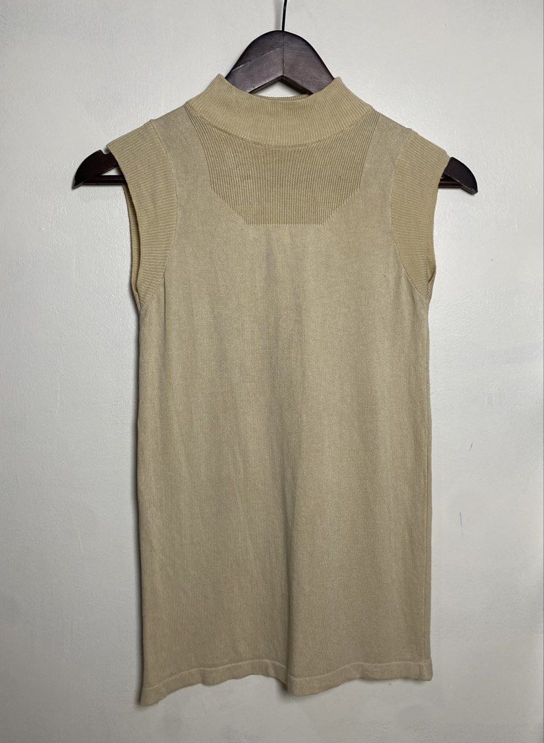 Beige mock neck sleeveless top (Category: Others Tops) located in Makati City. Submitted by indaysukaycloset (Listing ID 1465848477, Image 1). Description: BEIGE MOCK NECK SLEEVELESS TOP Brand: Japan Brand (no tag visible) Size: Fits XS-S up to medium kasi stretchable Color: Beige / Khaki / Nude Details: - W-13.5 L-22.5 (laid flat, in inches) - small sizing, fitted - Mock neck / high neck sleeveless knit - Ribbed neckline, armhole and shoulder de