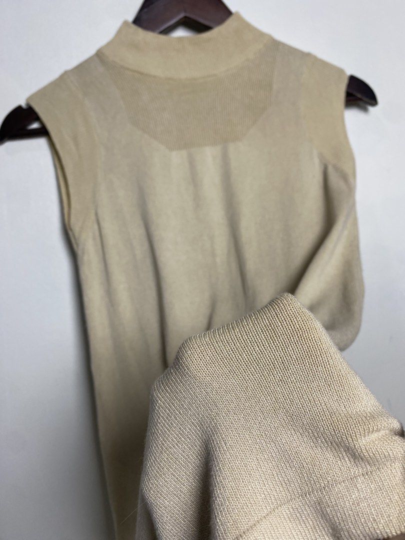 Beige mock neck sleeveless top (Category: Others Tops) located in Makati City. Submitted by indaysukaycloset (Listing ID 1465848477, Image 3). Description: BEIGE MOCK NECK SLEEVELESS TOP Brand: Japan Brand (no tag visible) Size: Fits XS-S up to medium kasi stretchable Color: Beige / Khaki / Nude Details: - W-13.5 L-22.5 (laid flat, in inches) - small sizing, fitted - Mock neck / high neck sleeveless knit - Ribbed neckline, armhole and shoulder de