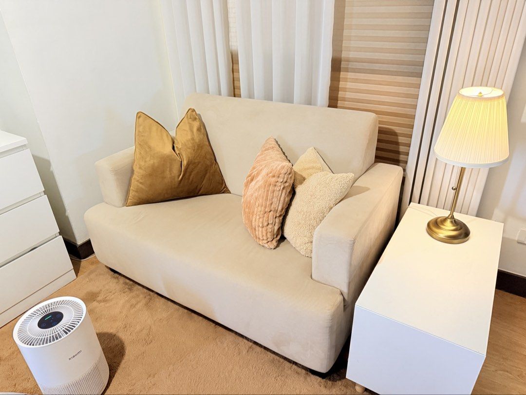 Beige Sofa (Category: Sofas) located in Taguig. Submitted by boxedgoodies (Listing ID 1465862026, Image 1). Description: - Compact 2-seater sofa - Light beige fabric - High backrest for optimal comfort - Sturdy solid wood frame underneath - Ideal for smaller living rooms or bedrooms.