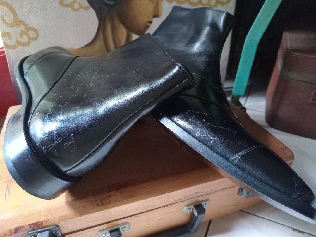 Berluti Black Leather Script Print Chelsea Boots (Category: Boots) located in Cagayan de Oro. Submitted by joven.uy86-31596 (Listing ID 1465825757, Image 3). Description: - Style: Statement black leather boots with striking script calligraphy print - Closure: Convenient side zipper for easy wear - Design: Structured toe cap and clean stacked heel - Finish: Polished look with distinctive pattern details throughout - Condition: Brand new / Excellen