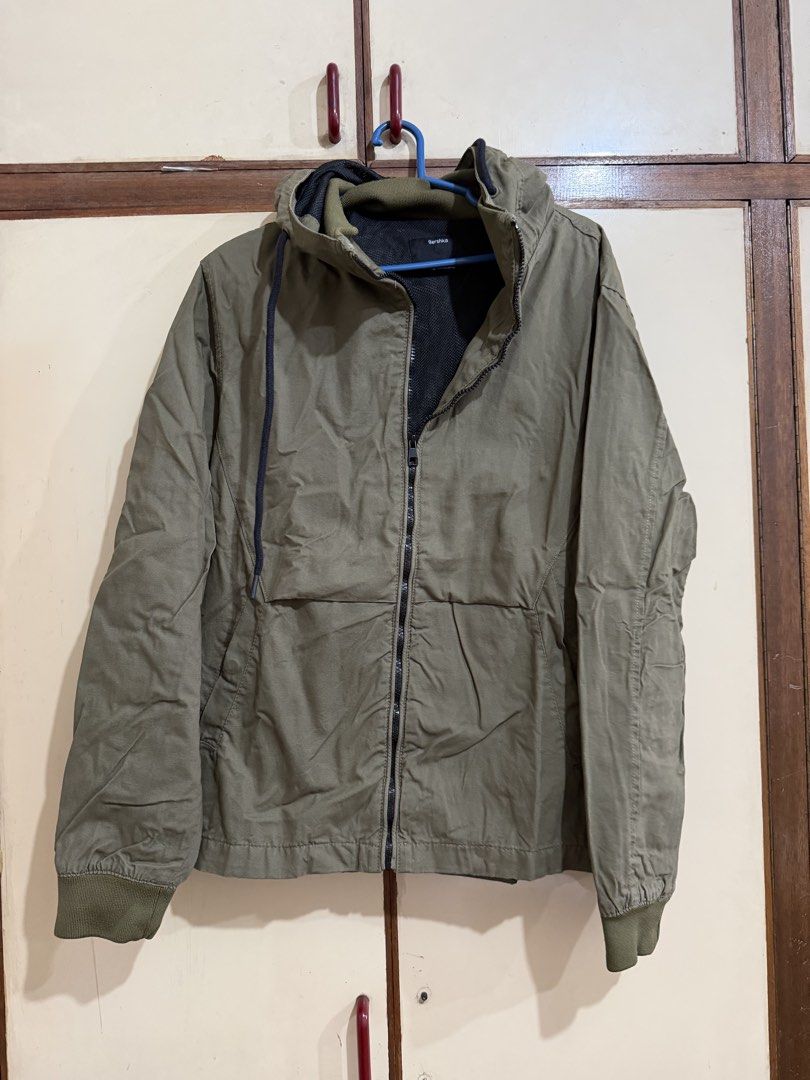 Bershka Olive Green Hooded Jacket Size M (Category: Coats, Jackets and Outerwear) located in Manila. Submitted by preloved_new_forsale (Listing ID 1465920458, Image 1). Description: Bershka hooded jacket in olive green. Medium size, EUR M, USA M, MEX 38. Full zip closure up front with dark drawstrings on the hood. Ribbed cuffs and hem. Black mesh lining inside. Made in Bangladesh. Good layer for cooler weather..