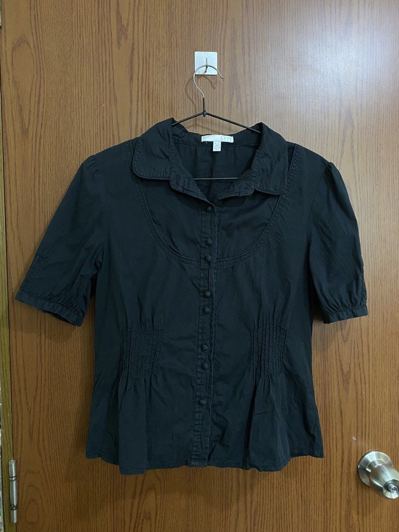 BETU Black Button-Down Short Sleeve Blouse Size L (Category: Blouses) located in Manila. Submitted by anneeem (Listing ID 1465784506, Image 1). Description: - Brand: BETU - Color: Black - Size L on Tag, recommended for Size Medium only - Design: Classic collar, front button fastening, unique curved yoke seam, and vertical waist pleating - Sleeves: Puffed short sleeves with button cuffs - Style: Versatile basic for casual wear or office styling.